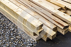 Stack of natural wooden boards on building site. Industrial timber for carpentry, building or repairing, lumber material for