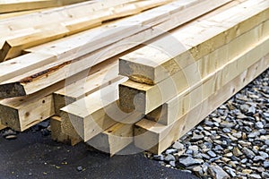 Stack of natural wooden boards on building site. Industrial timber for carpentry, building or repairing, lumber material for