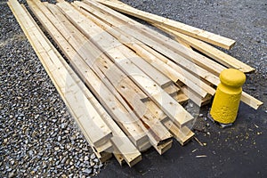 Stack of natural wooden boards on building site. Industrial timber for carpentry, building or repairing, lumber material for