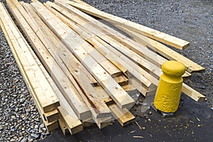 Stack of natural wooden boards on building site. Industrial timber for carpentry, building or repairing, lumber material for