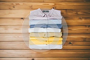 stack of naturally dyed cotton shirts on wood