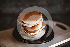 A stack of neat pancakes on a wooden stand