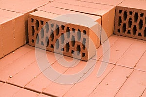 A stack of new red clay bricks