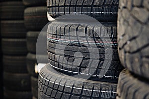 Stack of new tires sale at the auto shop. Pile of tires in stock