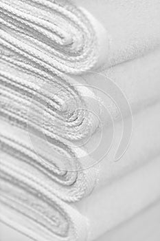 Stack of new white towels close-up - background