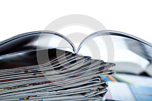 Stack of newspapers, magazine, and keyboard close-up