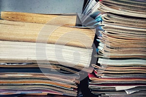 Stack of newspapers near a shelf