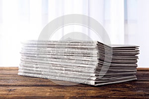 Stack of newspapers on table. Journalist`s work