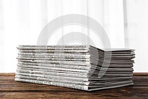 Stack of newspapers on table. Journalist`s work