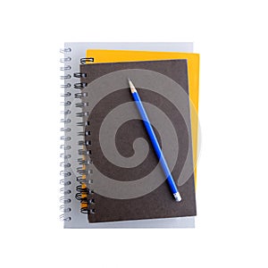 Stack of notebooks or copybooks with pencil on top