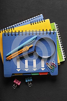 stack of notebooks and school supplies.