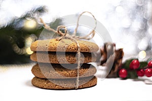 A stack of oatmeal cookies, in the background. christmas decorations and bokeh. Gifts for loved ones for Christmas and New Year.