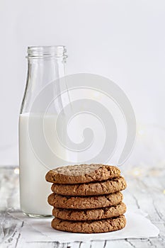 Stack of Oatmeal cookies with bottle of milk