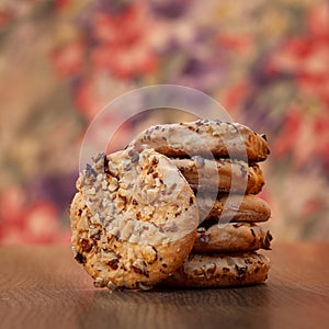 Stack of a oatmeal cookies shot on a wooden table. Shot with a shallow depth of field and a warm color tone.