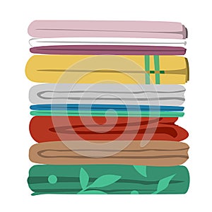 Stack of old bedroom linen of different patterns and colors. Quilts, comforters, and duvet covers pile isolated on white