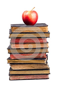 Stack of old books and apple on it