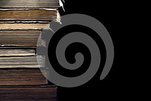 Stack of old books on the black background