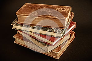 Stack of old books on black background