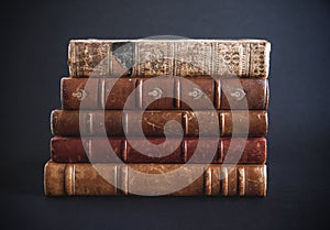 Stack of old books on black background