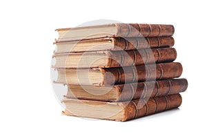 A stack of old books bound in brown leather, isolated on a white background. Space for text