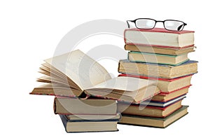 Stack of old books with glasses