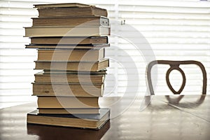 Stack of old books on kitchen table for study school