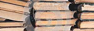 Stack of old books on a library shelf. Panoramic picture