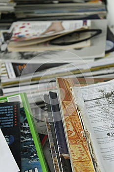 Stack of old books and magazines on a table- Close up