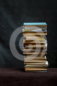 A stack of old books and notebooks on the table