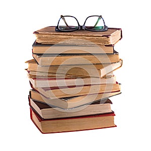 Stack of old books and spectacles in thick-rimmed