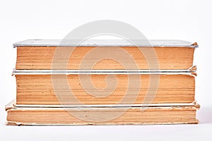 Stack of old books, white background.