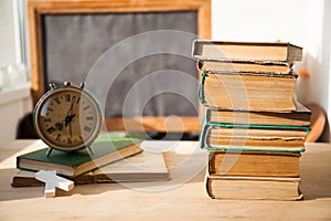 Stack of old books on wood desk