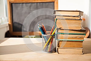 Stack of old books on wood desk