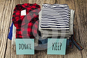 Stack of old clothes to discard declutter or keep. Recycle clothes, eco cotton photo