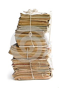 Stack of old and dusty magazines isolated on white