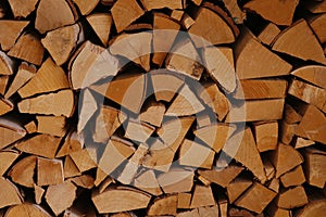 Stack of old firewood texture background.Fireplace wood, cordwood, splitwood.stored logs, wood and lumber