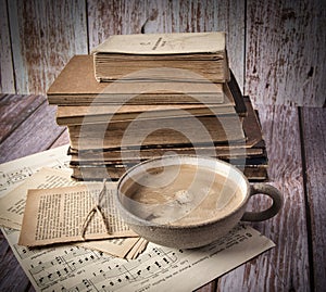 Stack of old hardcover books an a cup of coffee
