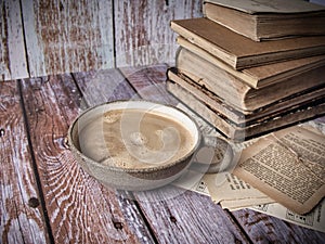 Stack of old hardcover books an a cup of coffee