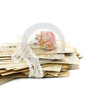 Stack of old love letters, lace and rose flower