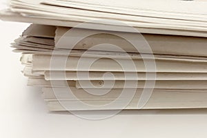 stack of old newspapers isolated on a white background.