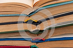 Stack of old open books for background