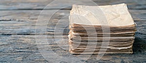 stack of old papers on a wooden surface