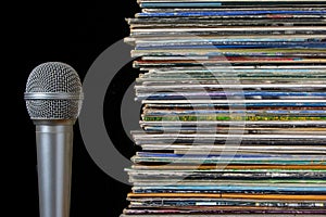 A stack of old records and microphone