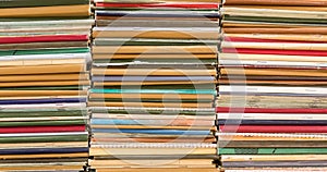 A stack of old school notebooks. Multicolored cover