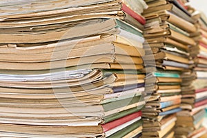 A stack of old school notebooks. Multicolored cover