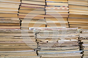 A stack of old school notebooks and a stack of textbooks or books