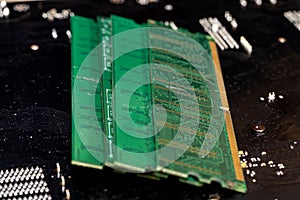 A stack of old SDRAM memory modules lying on a printed circuit board.