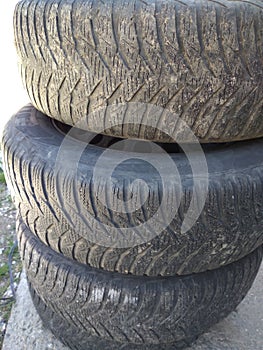 Stack of old used car tires, tire wear and change concept. Bucharest, Romania, 2021