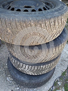 Stack of old used car tires, tire wear and change concept. Bucharest, Romania, 2021