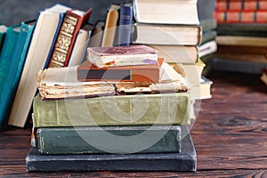 Stack of old vintage books on wooden shelf in university library